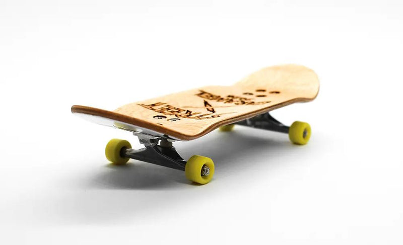 Street x Caramel Conan 36mm complete fingerboard with natural wood deck, black trucks, and yellow wheels.