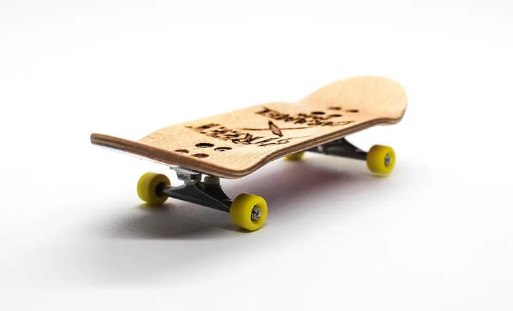 Street x Caramel Doctor Strange 34mm complete fingerboard with natural wood deck, black trucks, and yellow wheels.