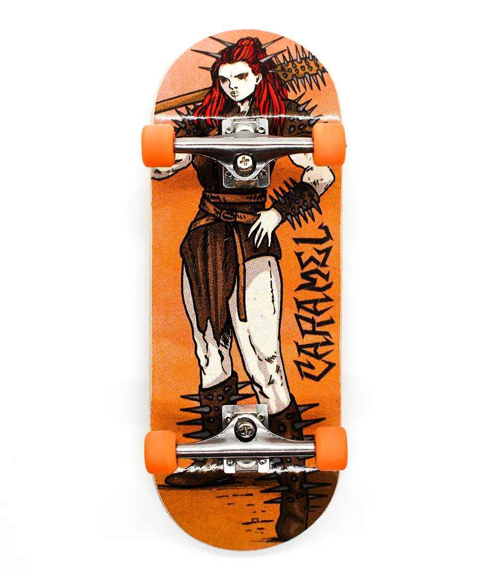 34mm Street x Caramel Warrior Woman fingerboard with orange wheels and a fierce warrior graphic.