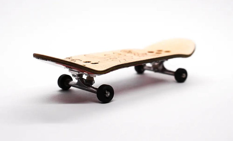 Mike FB x Caramel Hello 34mm complete fingerboard with natural wood deck, silver trucks, and black wheels.