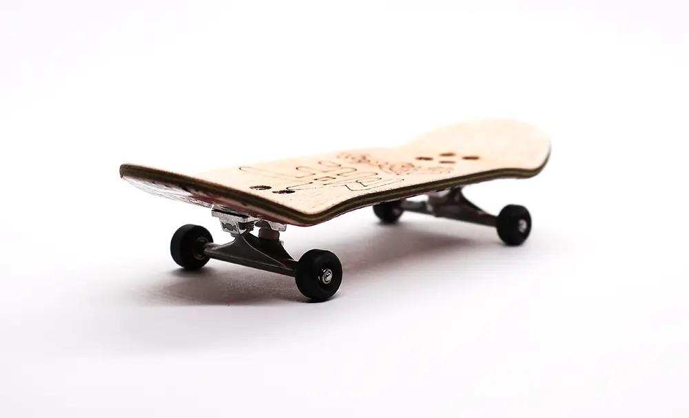 Mike FB x Caramel "Hello My Name" 34mm complete fingerboard with natural wood deck and black trucks/wheels.